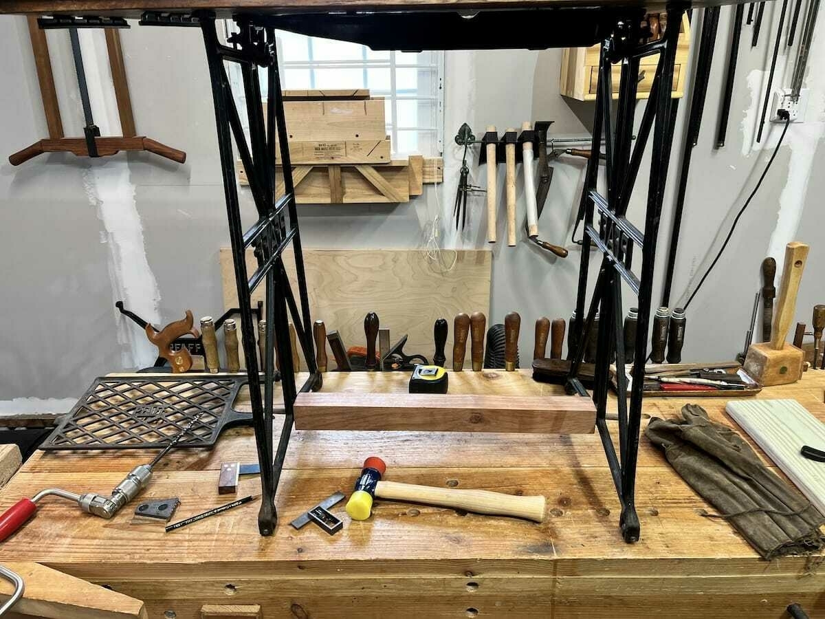 front view of sewing machine table with bubinga lower bar held in by dowels