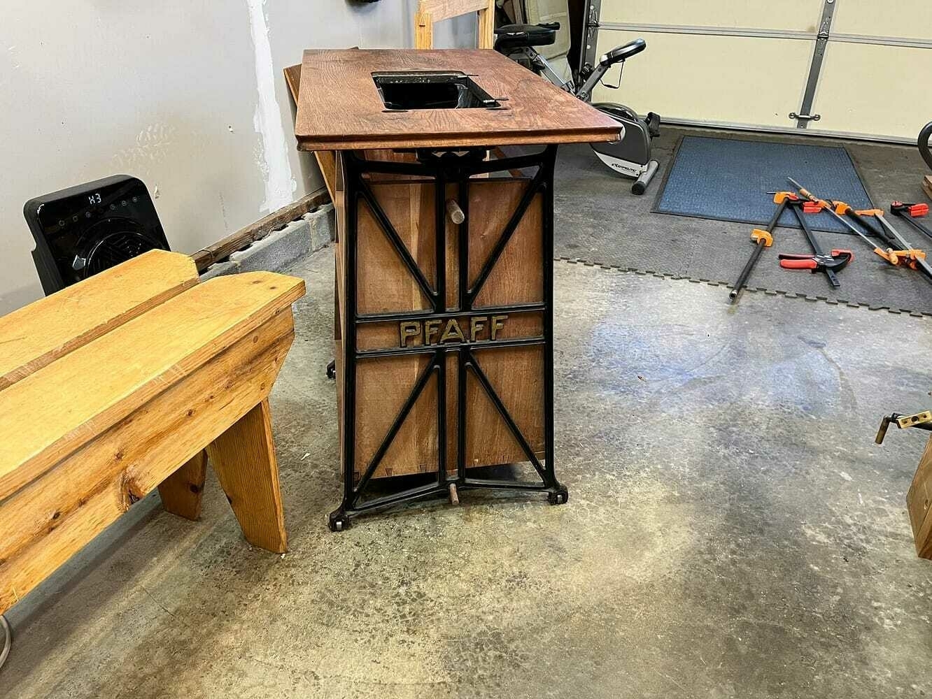 Side view of cabinet showing dowels holding it in place in the iron frame.