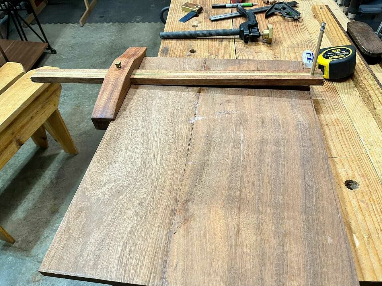 Preparing to cut the base by marking lines on benchtop.