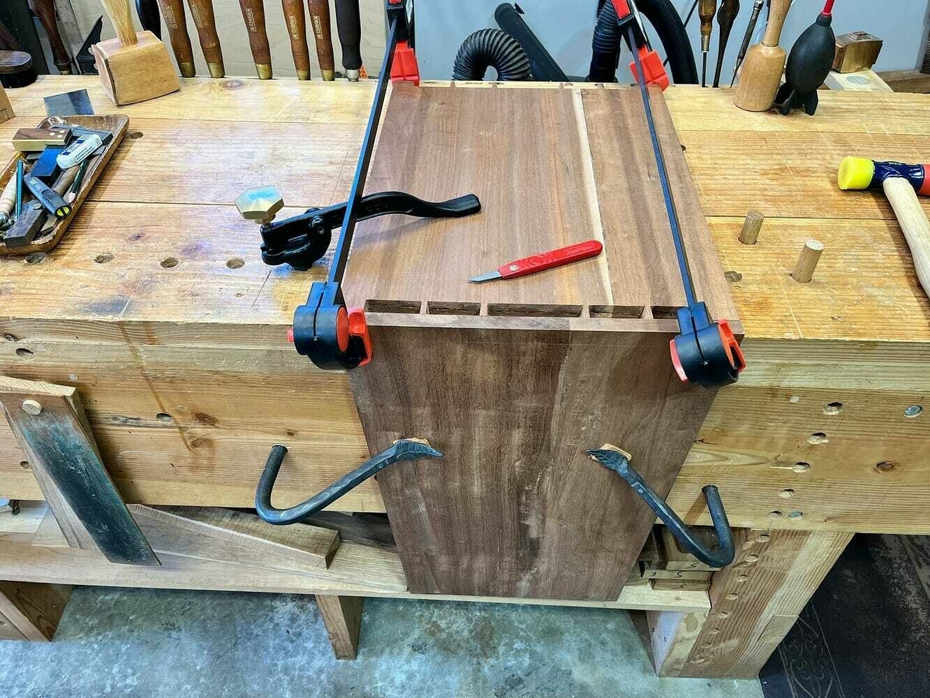 Aligning the pins to mark out the tails in the cabinet